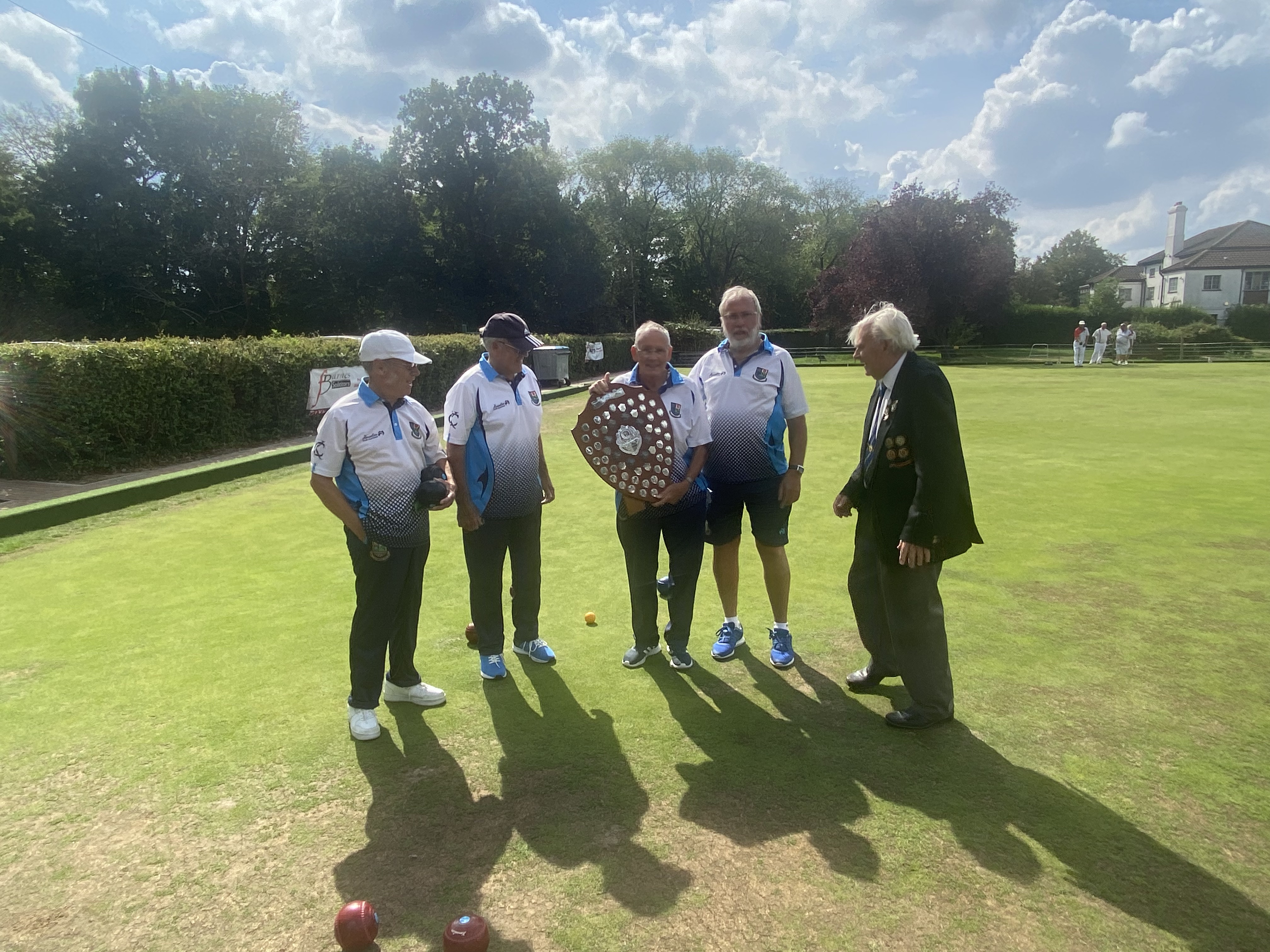 photo showing the winners with the trophy.